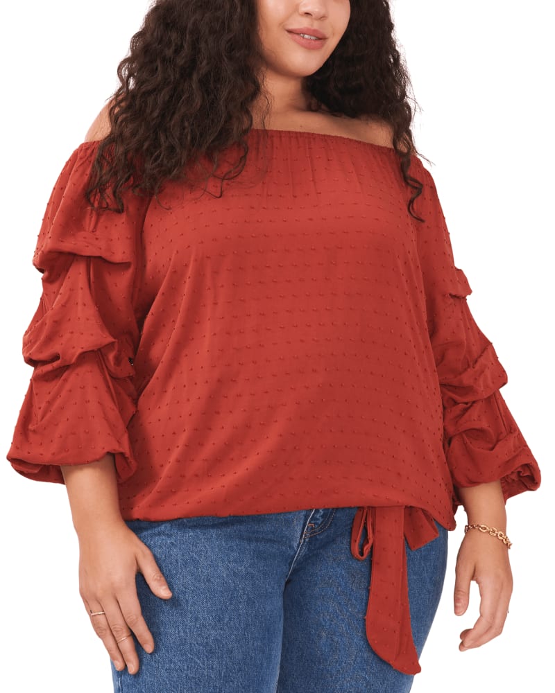 Front of a model wearing a size 1X Flora Swiss Dot Blouse in RUST by Vince Camuto. | dia_product_style_image_id:260863